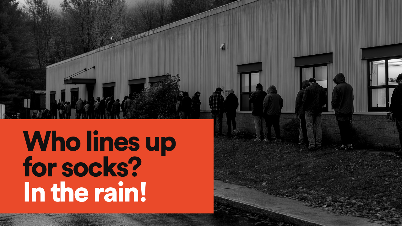 A line of people outside a sock factory